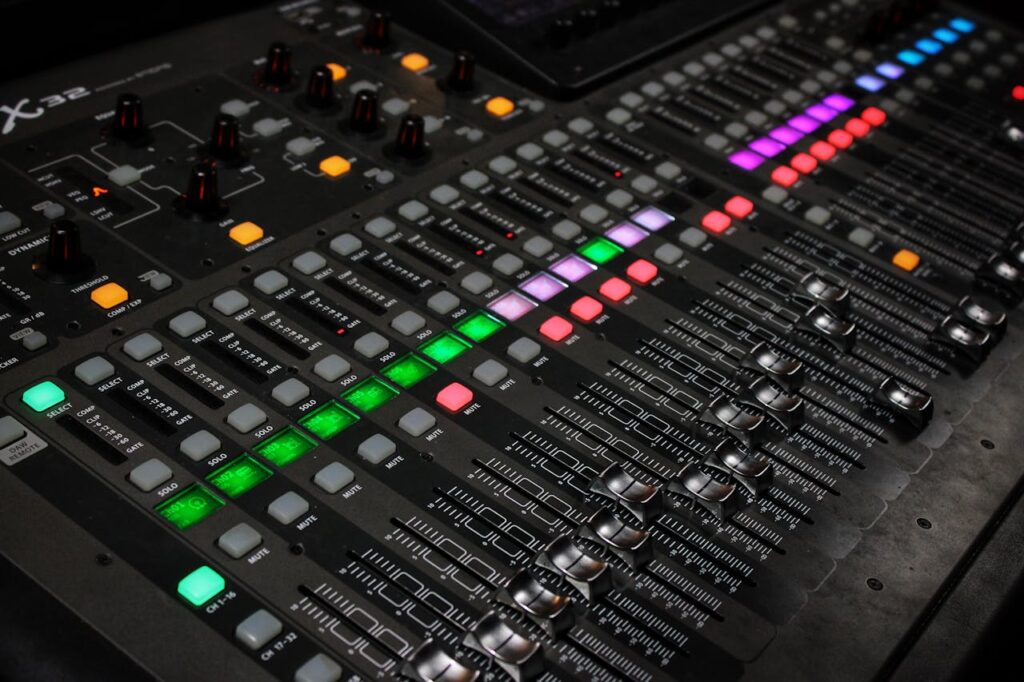 pexels photo 28758925 Detailed view of audio mixing console with glowing LED buttons.