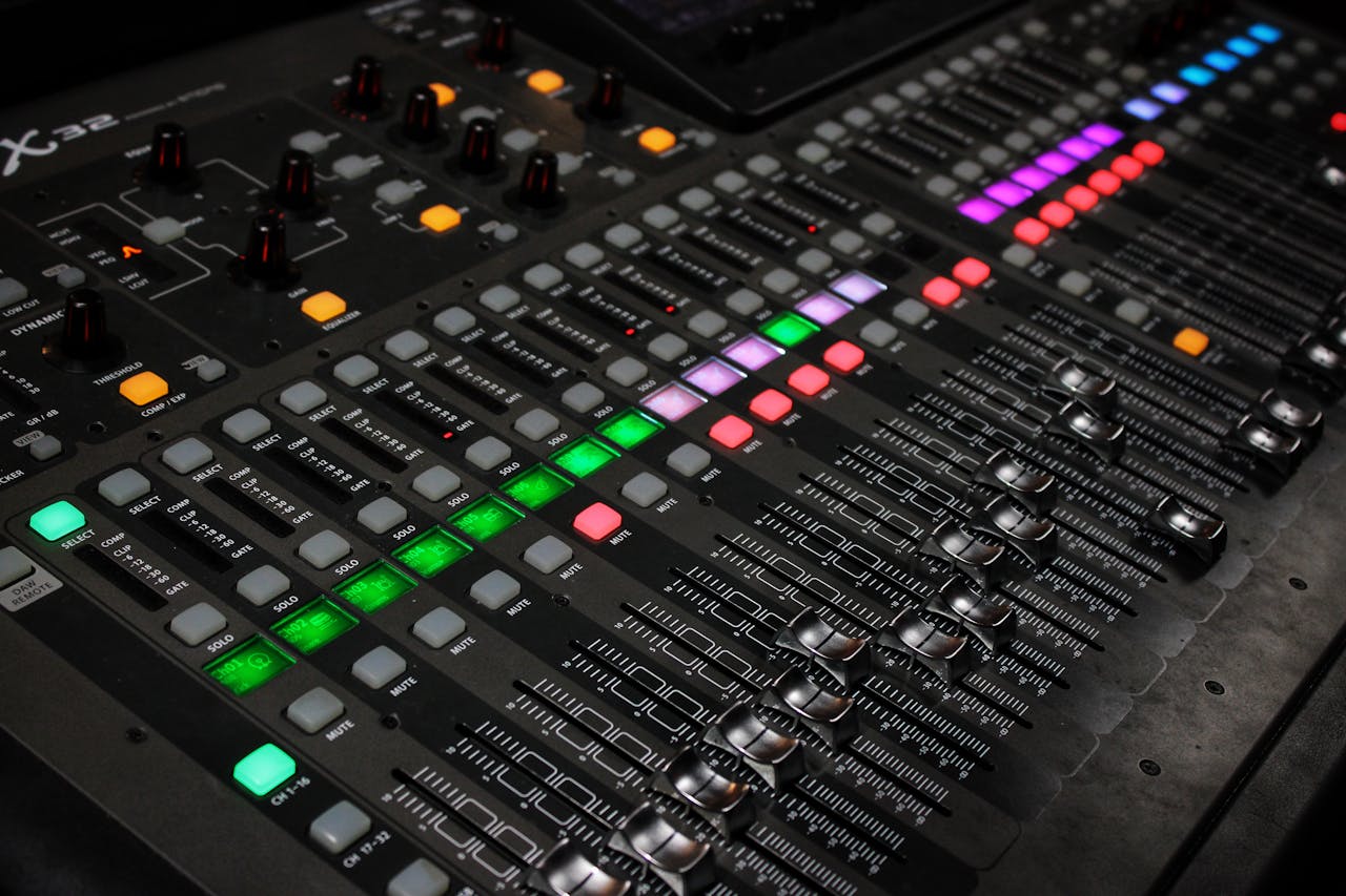 gallery-3 Detailed view of audio mixing console with glowing LED buttons.