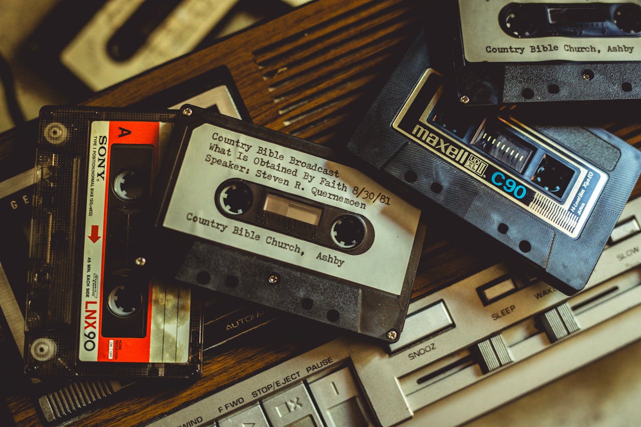 gallery-5 Collection of vintage cassette tapes and player, evoking nostalgia and retro vibes.
